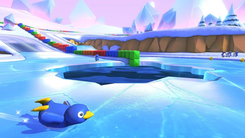 A penguin toboggans across the racetrack in Snow Land.